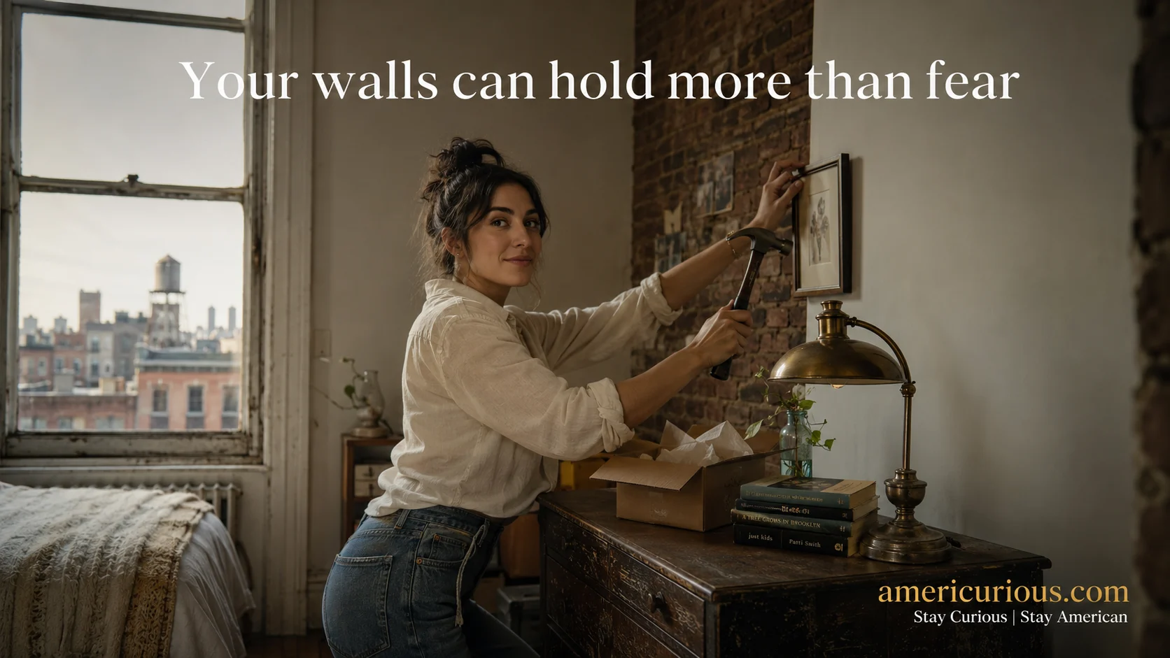 Woman hanging framed art with a single nail in a small NYC studio apartment — small NYC apartment decor tips, americurious.com
