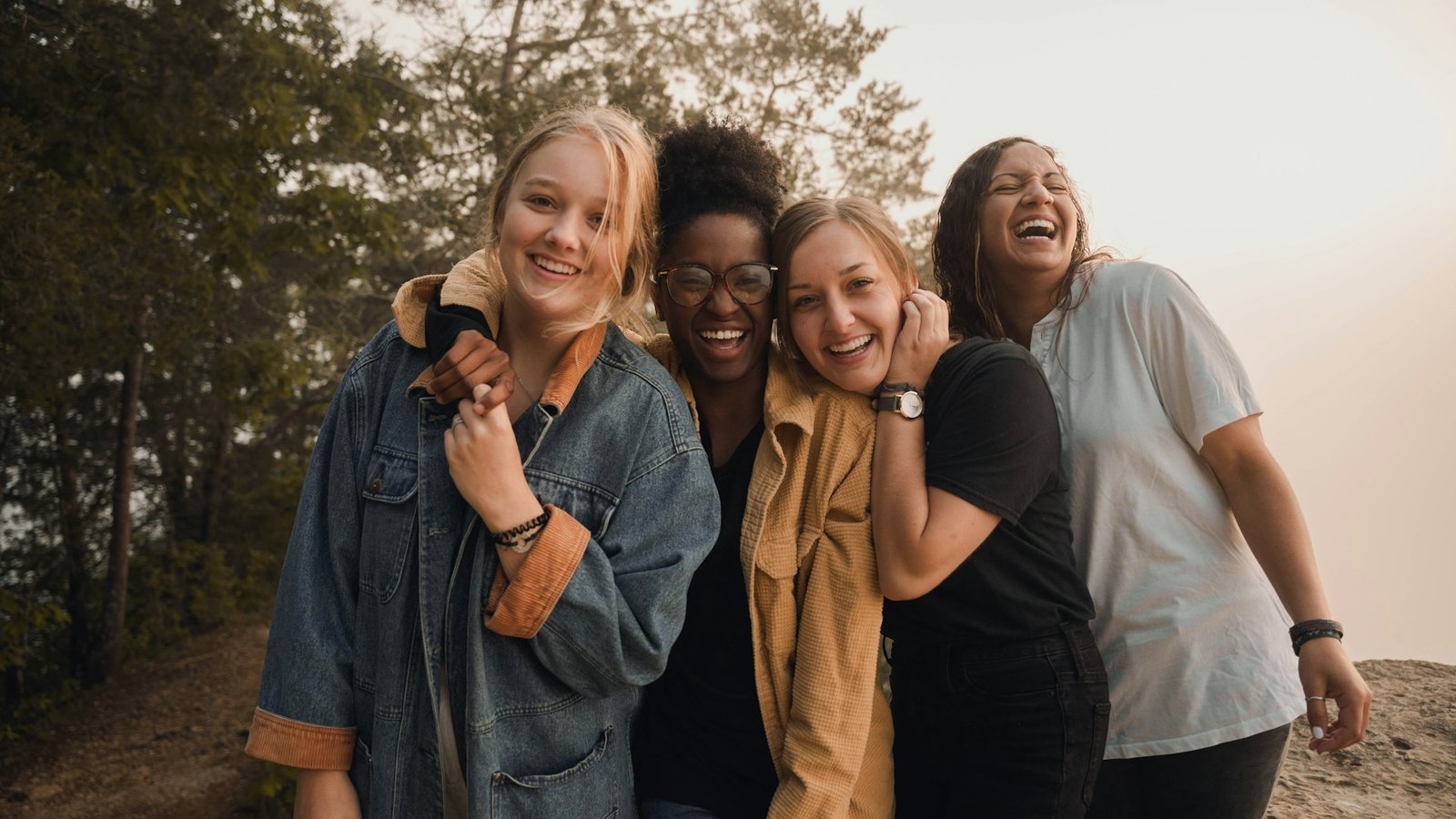 four-women-laughing-outdoors-together